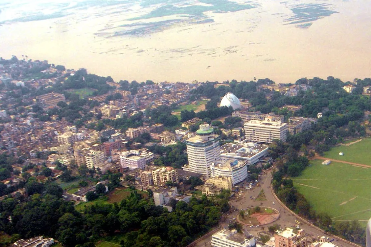Aerial view of Patna with buildings, a large green ground and the flooded Ganga in the background