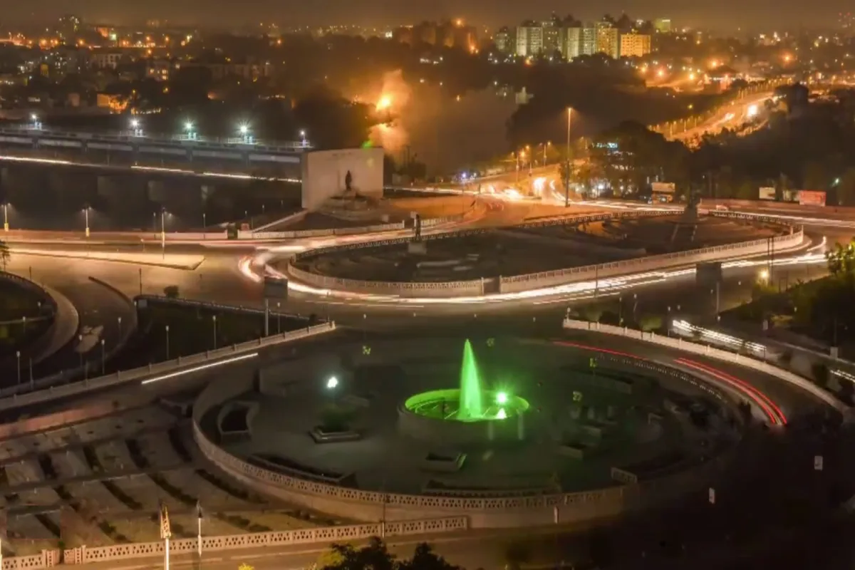Night view of Lucknow from Gomti Nagar with a lit roundabout, a green-lit fountain and light trails