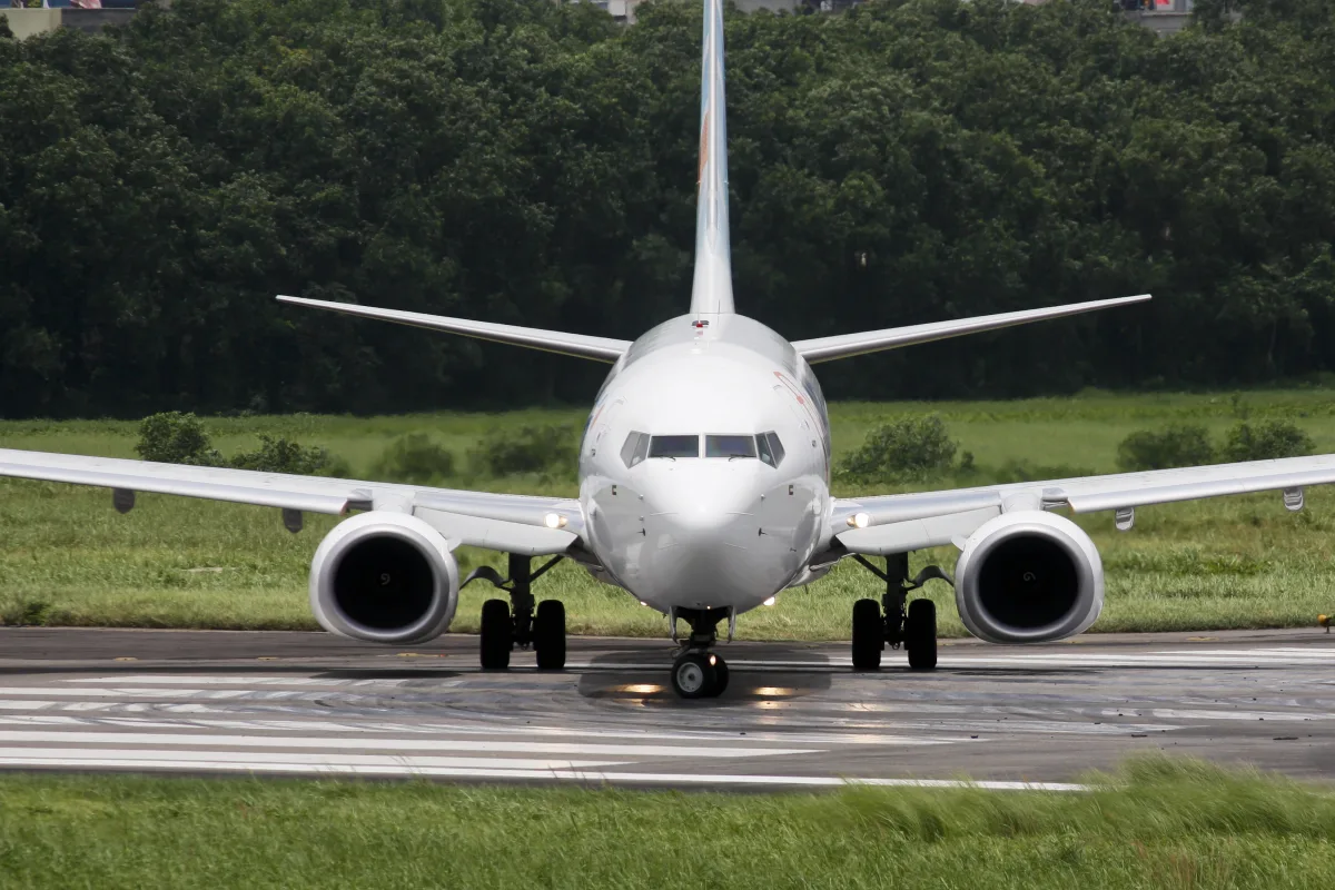 A white flydubai Boeing 737-800 taxiing on a runway