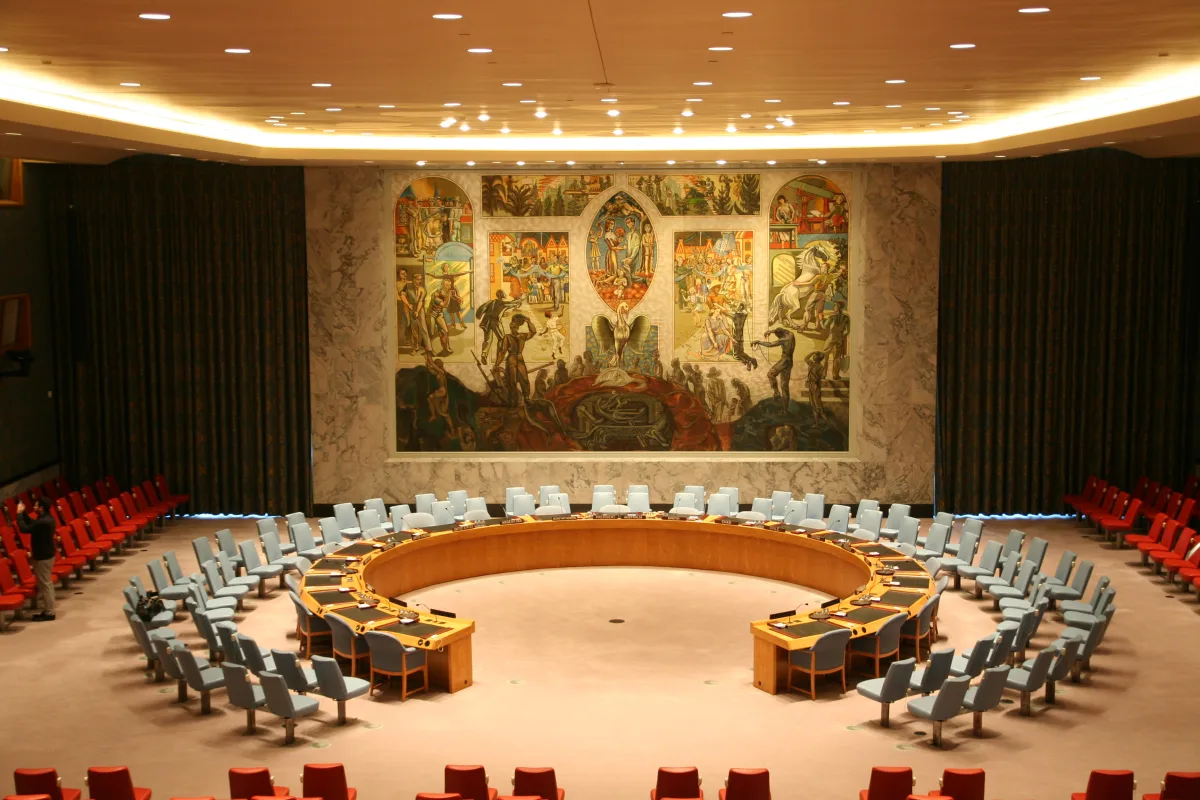 The UN Security Council chamber in New York with its horseshoe table and mural